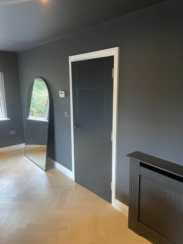 Charcoal walls with a matching dark door