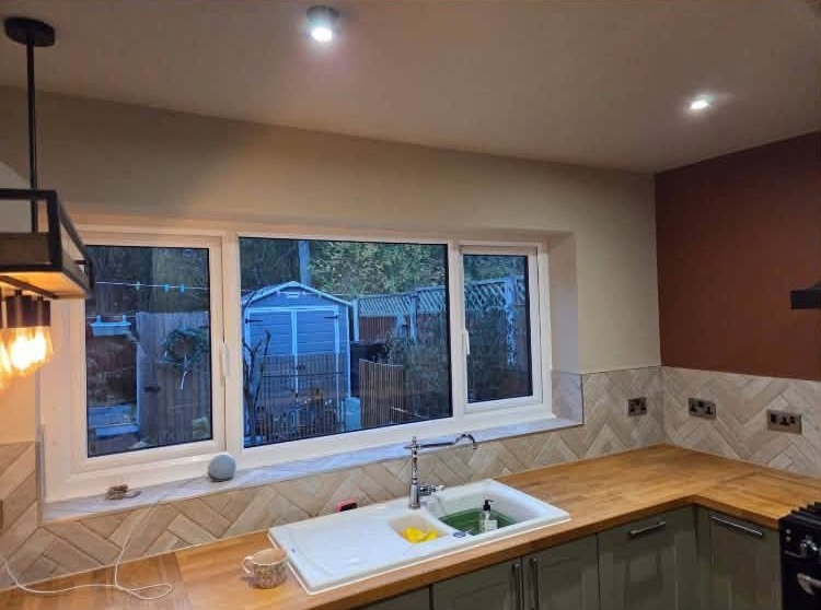 Kitchen with a terracotta wall above the window