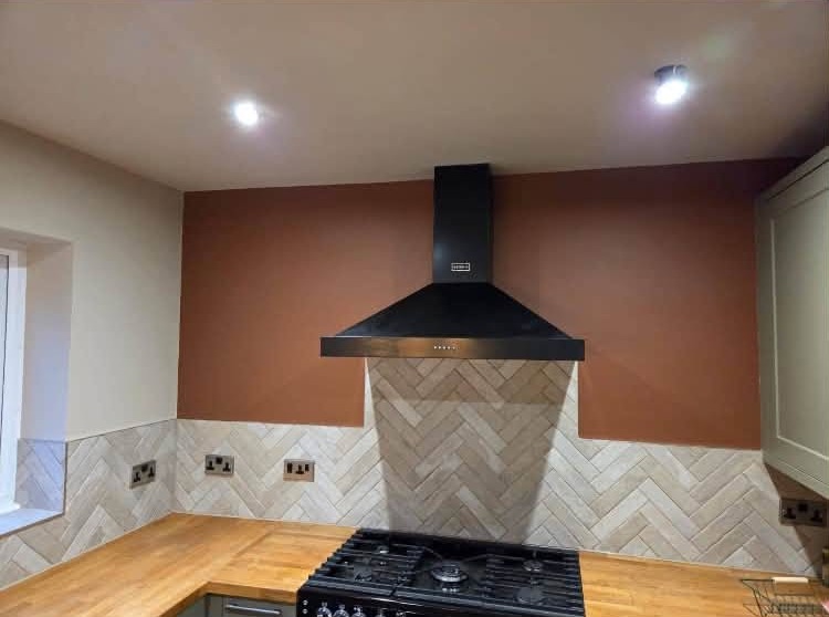 Kitchen chimney breast painted terracotta above the range