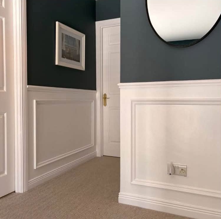 Hallway with white box panelling below deep blue walls
