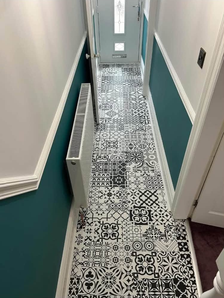 Hallway in teal and white above a patterned tiled floor