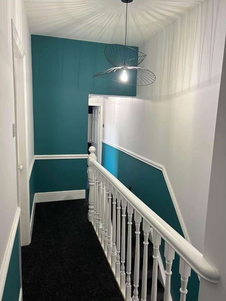 Landing in teal with a white banister