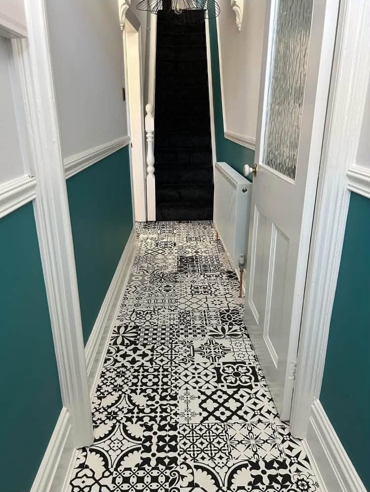 Teal and white hallway looking towards the front door