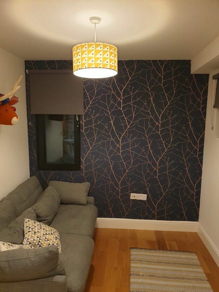 Navy feature wall with a copper branch pattern