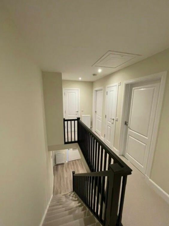 Landing and staircase finished with white doors, skirting and black spindles