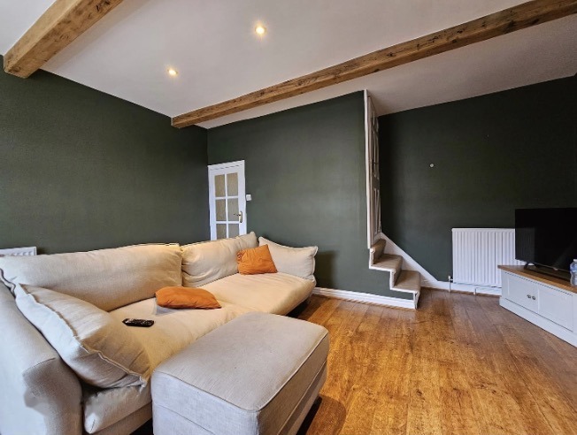 Dark green lounge with exposed beams