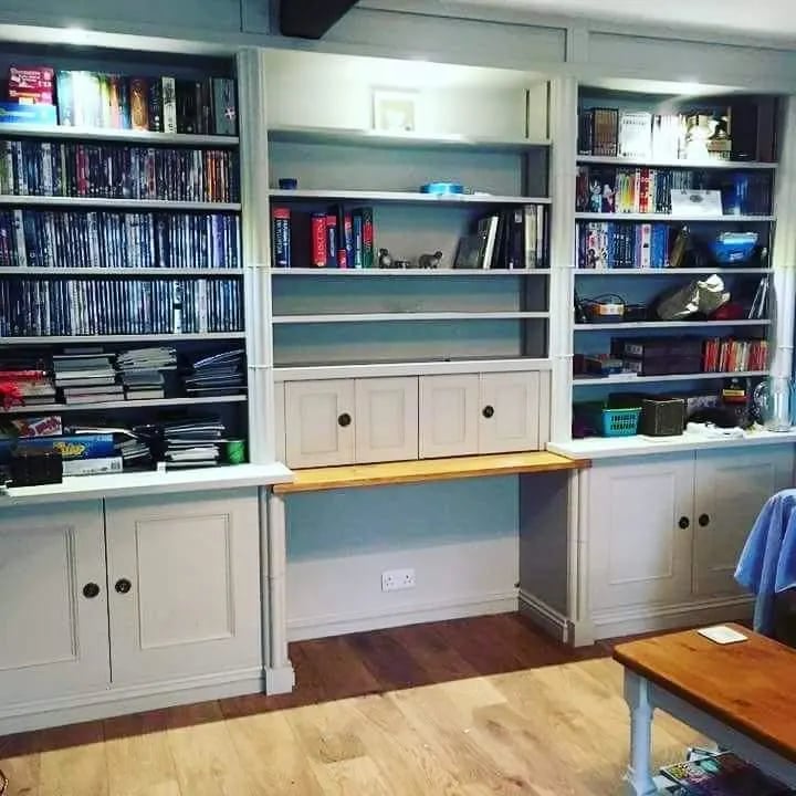 Built in alcove shelving and cupboards painted in soft grey